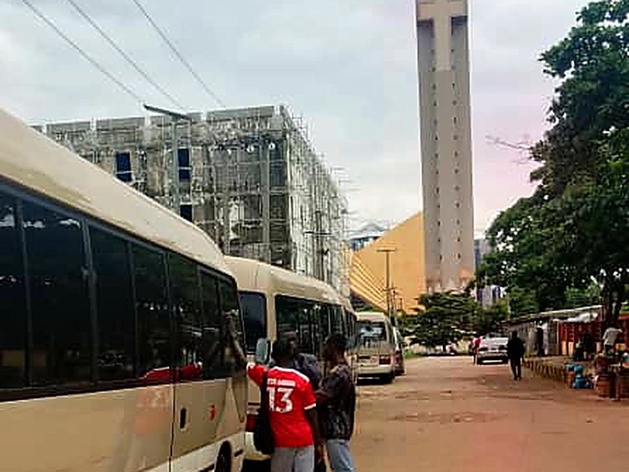 Staff boarding a Coaster bus at a scheduled pick-up point in Abuja