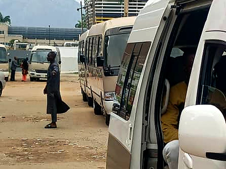 Hiace van and a line of Coaster buses staged in the Central Area, Abuja